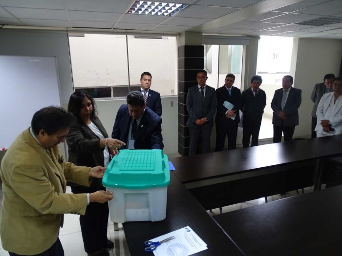 El Dr. Fernando Salazar Silva apertura los sobres con las preguntas de la evaluación.
